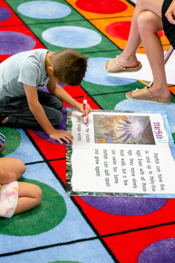 Boy writing on Big Book for Handwriting and the Bilingual Literacy Connection